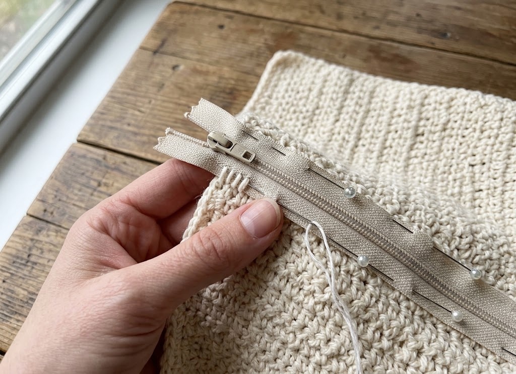 Sewing a zipper onto a crochet pencil case panel